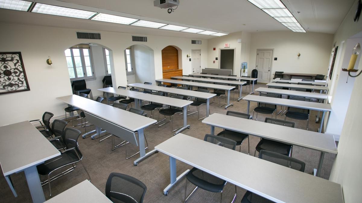 Seven rows of desks in the 3rd floor classroom at Holt Center